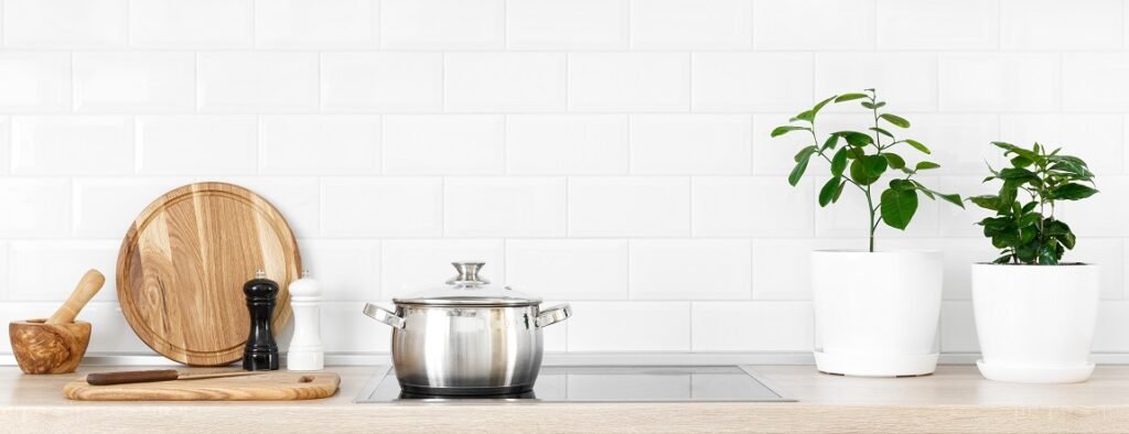 White modern kitchen interior with wooden worktop and kitchenware, culinary concept, background, banner